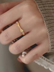 Detail of 18K gold-plated ring featuring white mother-of-pearl and five micro-zircon stones