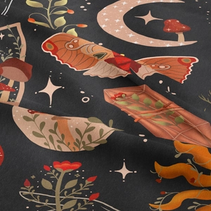 Detailed macro view of moth and celestial mushroom motifs on dark grey cotton fabric