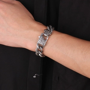 Close-up of vintage silver engraved clasp on thick punk titanium steel chain bracelet