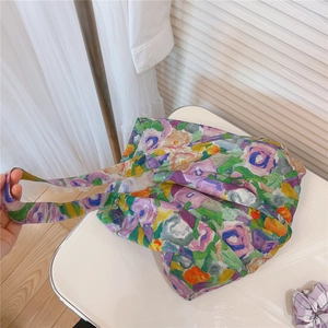 Detail view of floral print canvas tote bag with matching purple plaid hair scrunchie