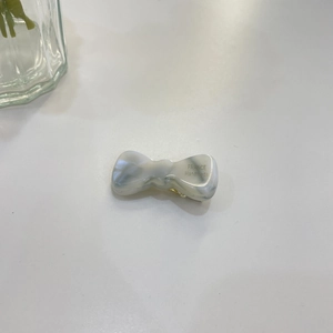 Detail of grey marble acetate bow hair clip with FRANCE Handmade engraving detail