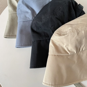 Close-up of four twill cotton sun hats in khaki, light blue, black and beige colors