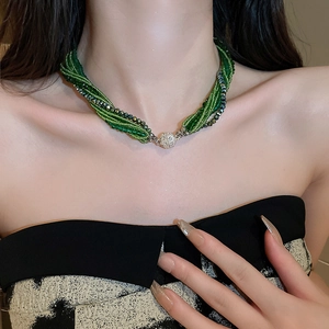 Detailed view of multilayer green beaded necklace with sparkling rhinestone magnetic clasp