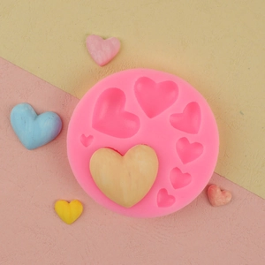 Pink heart-shaped silicone mold with various sizes of cavity for fondant and chocolate DIY