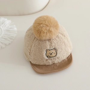 Chapeau d'hiver beige pour bébé en laine d'agneau avec pompon et visière en velours