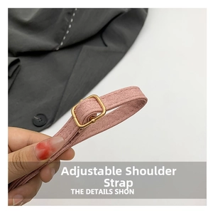 Detail of adjustable pink fabric shoulder strap with premium gold metal buckle