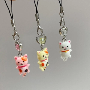 Three cute Y2K resin cat keychains in pink, yellow and white with heart charms
