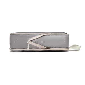Detail of grey compression travel cube with diamond ripstop pattern and sturdy handle