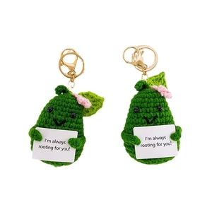Handmade crochet avocado keychains with inspirational message cards on white background