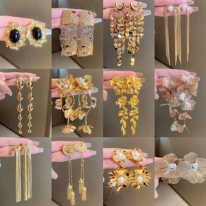 Collection of 12 luxury gold floral and bow tassel earrings with crystals and pearls