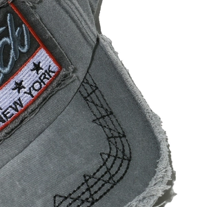 Detail of vintage gray baseball cap with spider web stitching and New York embroidery