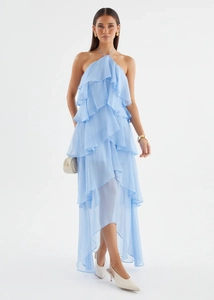 Detail view of light blue halter dress featuring tiered ruffles and asymmetric hemline