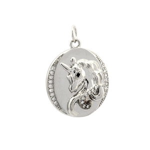 Macro shot of silver unicorn pendant with cubic zirconia inlay and metallic finish