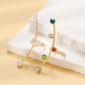 Elegant gold earrings with water drop tassels, white pearls, and colorful zircon crystals