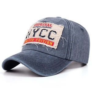 Close-up of vintage blue baseball cap with distressed original fashion embroidery patch