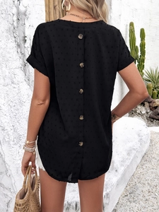 Detail of black short sleeve top featuring decorative back buttons and polka dot texture