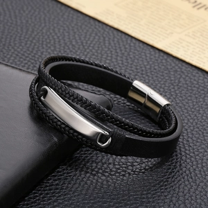Close-up of black multi-layer braided leather bracelet with silver metal plate and magnetic clasp