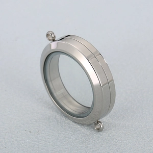 Detailed close-up of a silver circular screw-open locket pendant with clear glass panels