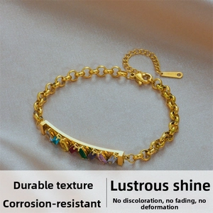 Detail of colorful rectangular gems set in gold stainless steel chain with lobster clasp