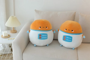 Plush astronaut and robot potato pillows with soft fabric detail on a cozy sofa