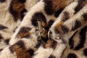 Detailed close-up of leopard print faux fur coat featuring soft texture and hidden metal hooks