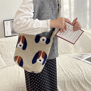 Close-up of plush fleece shoulder bag with cartoon dog pattern and thick soft texture
