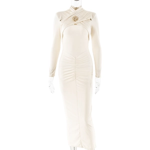 Detail of cream long sleeve dress featuring a metal ring and elegant front ruching