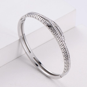 Macro detail of silver geometric hollow bracelet with sparkling cubic zirconia inlays