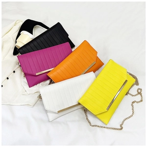 Collection of textured envelope clutch bags in black, white, and bright neon colors