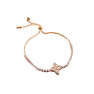 Sparkling zircon flower adjustable bracelet in gold finish with sliding closure on white background