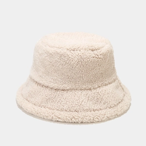 Detailed macro view showing the thick, warm lamb wool texture of the beige bucket hat