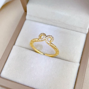 Macro shot of gold adjustable ring with pavé-set zircons and geometric relief patterns