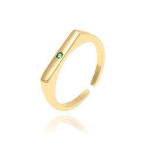 Macro detail of a gold open ring featuring a geometric bar set with a green zircon