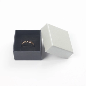 Detailed top view of a gold oval hollow ring inside a square jewelry gift box
