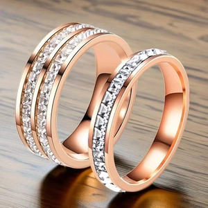 Macro shot of rose gold titanium steel couple rings with sparkling cubic zirconia inlay