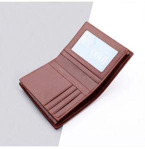 Close-up of brown leather bifold wallet featuring multiple card slots and ID window