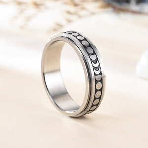Fidget spinner ring with engraved moon phases pattern in polished stainless steel