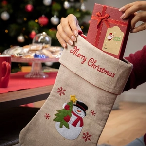 Christmas gift set with embroidered snowman stockings, red boxes and kraft paper labels