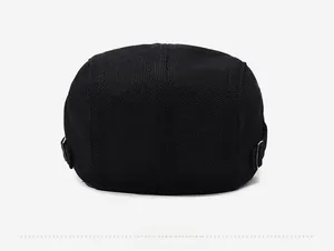 Detail view of the black breathable mesh flat cap with adjustable metal back buckle