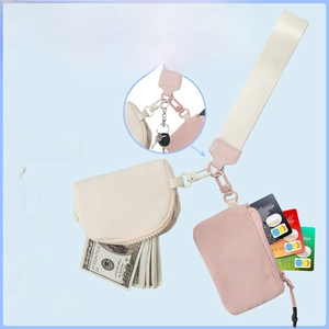 Detail view of water-resistant nylon wristlet pouches for keys, cards, and lipstick