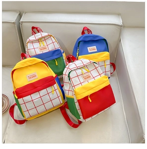 Four colorful canvas backpacks for toddlers featuring plaid patterns and contrasting colors
