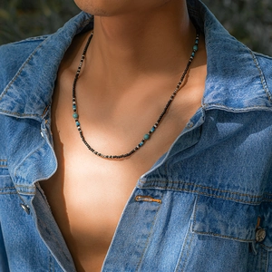 Bohemian beaded necklace for men featuring blue turquoise and black beads on male model