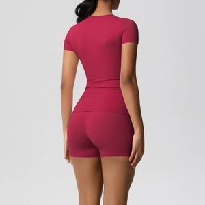 Rear view of tight-fitting high-stretch yoga shorts and short sleeve top in magenta
