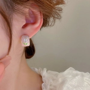Detailed close-up of a model wearing elegant square enamel tulip earrings with gold plating