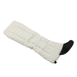Close-up of cream white cable knit leg warmers with thick winter braiding texture