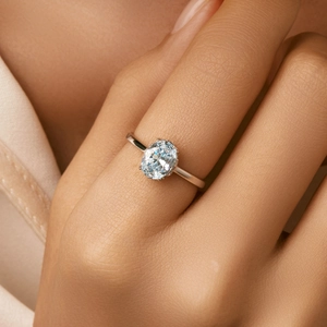 Elegant S925 sterling silver ring with oval light blue gemstone shown on a model hand