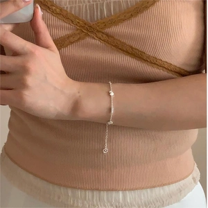 Minimalist S925 sterling silver chain bracelet with flat heart charms on female wrist