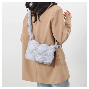 Close-up of light purple quilted nylon shoulder bag with stylish scrunchie strap detail