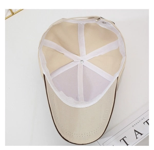 Detailed interior of a beige baseball cap showing reinforced seams and breathable mesh