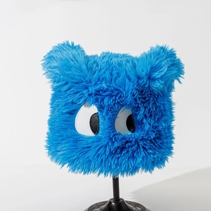 Detail of plush bucket hat in light blue with cartoon eye pattern and soft fuzzy texture
